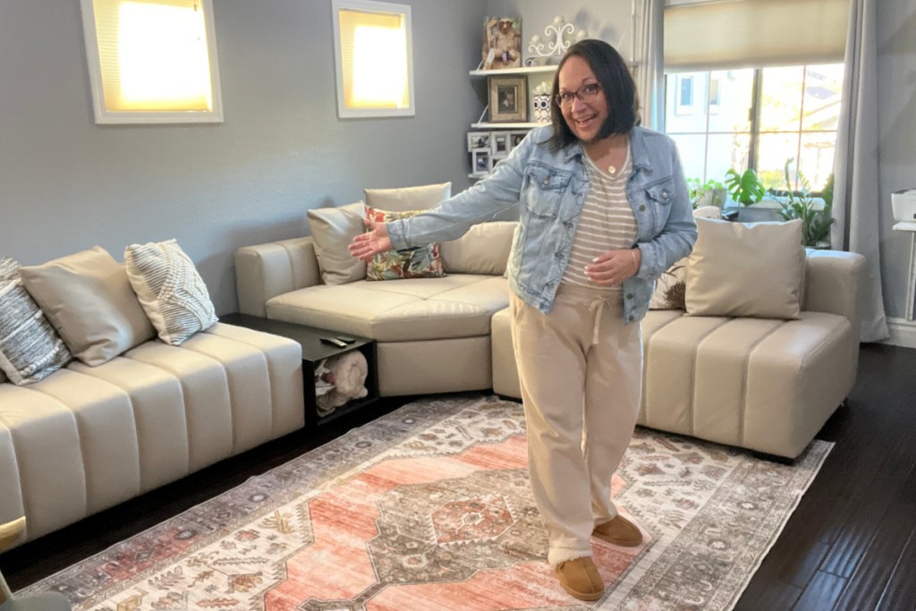 woman standing in front of sectional couch