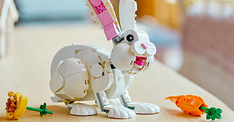 lego white bunny rabbit with carrot and flower on table