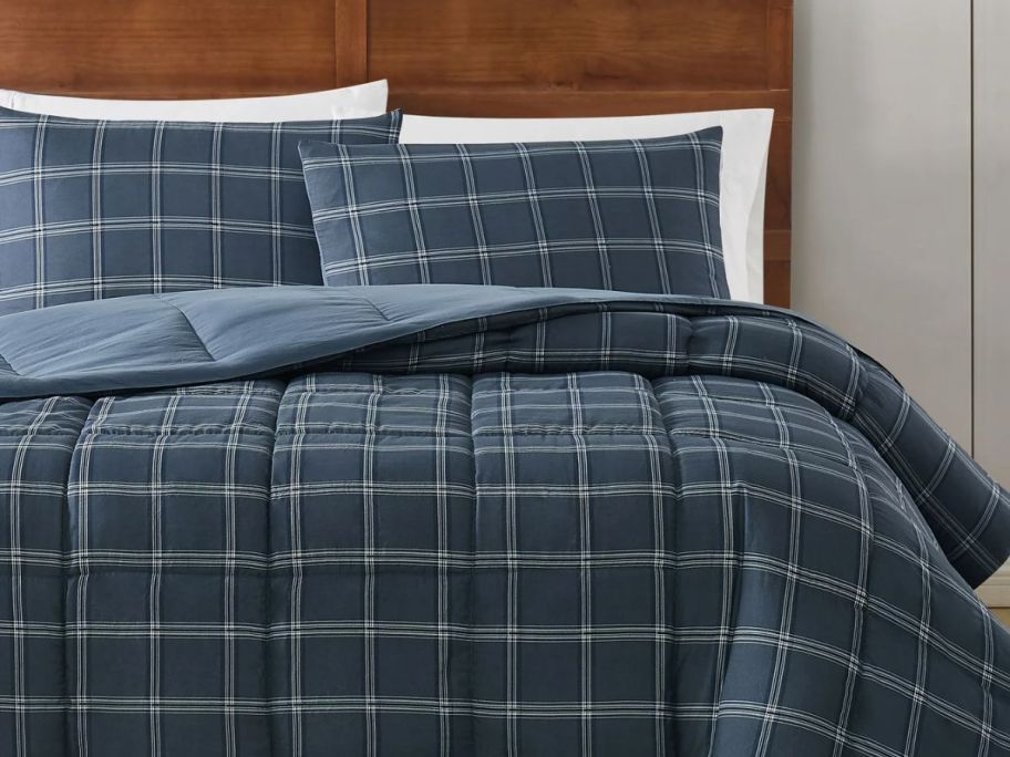 navy plaid comforter set on a bed