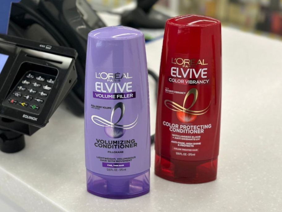 two bottles of elviev shampoo on counter