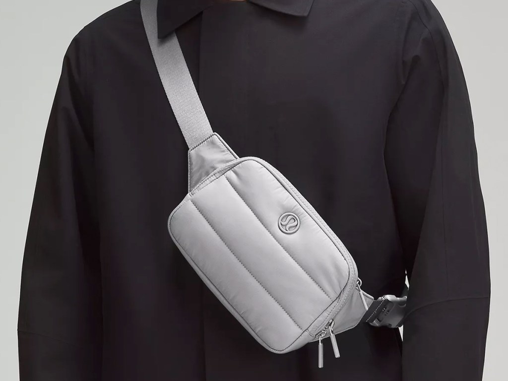 person wearing a grey lululemon belt bag over shoulder