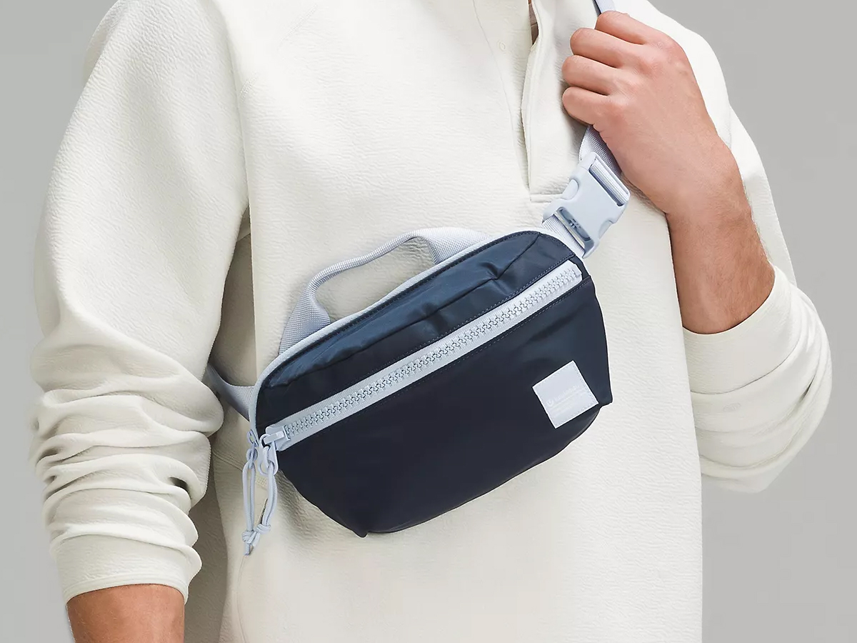 man in white shirt wearing blue lululemon belt bag across chest