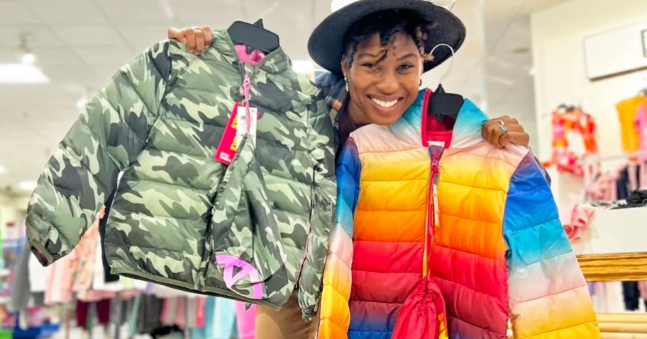 woman holding camo and rainbow colored puffer jackets