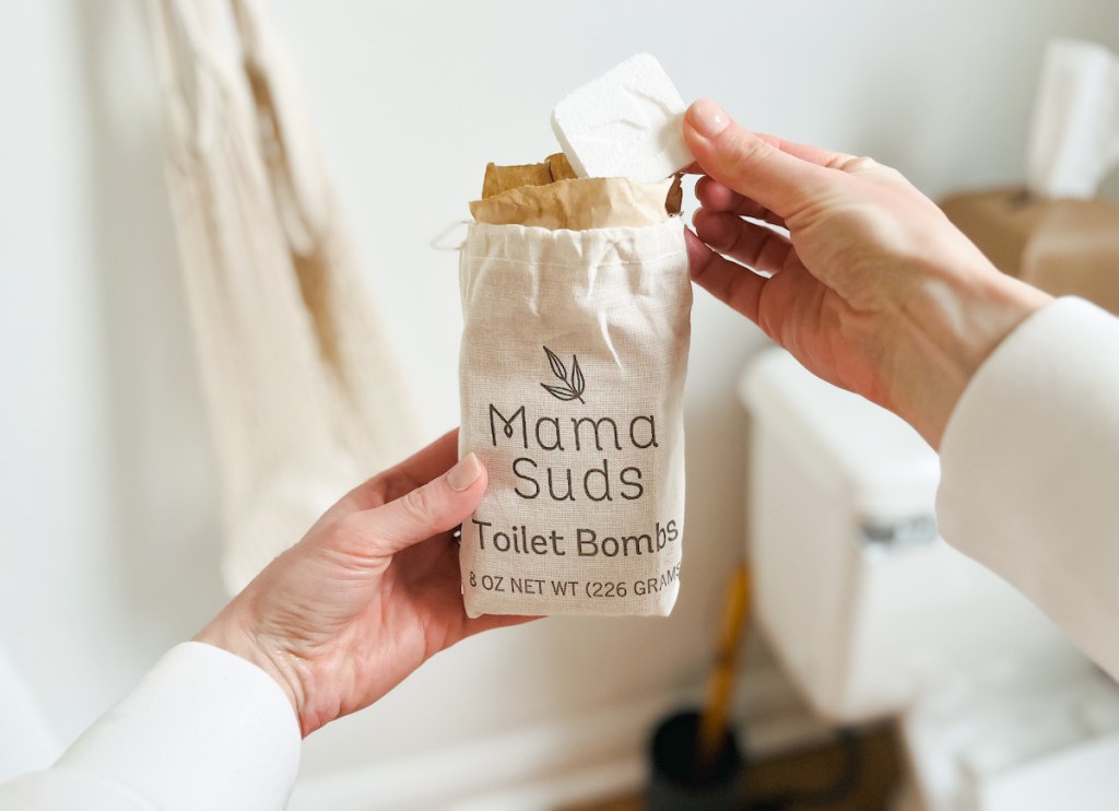 hand holding mama suds toilet bombs pack