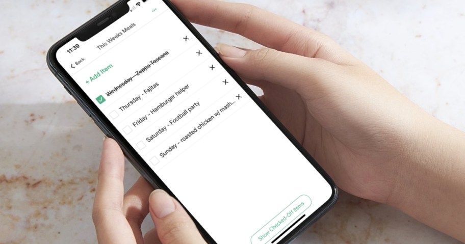hands holding phone with weekly meal plan