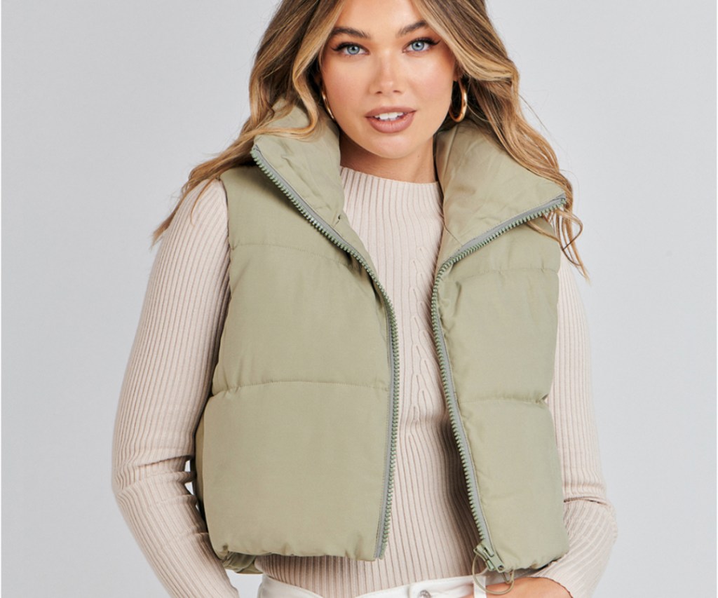 woman wearing light green puffer vest