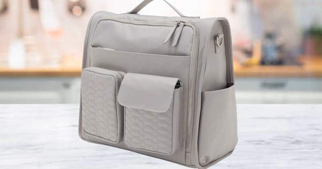 Gray diaper bag sitting on marble countertop
