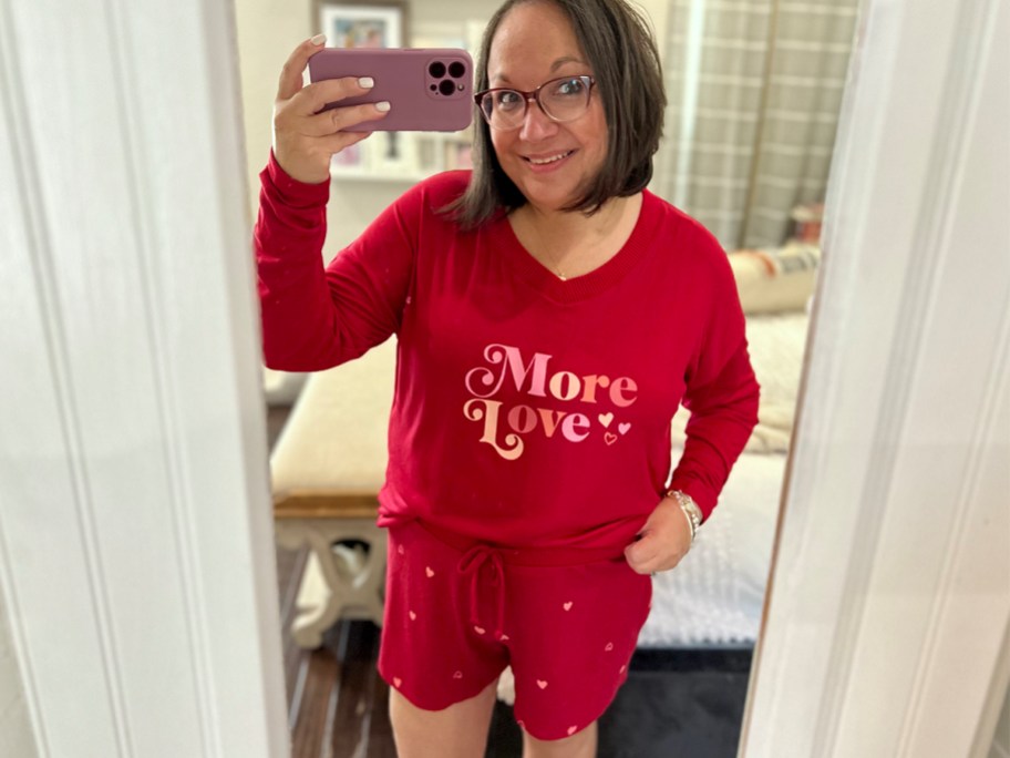 woman taking photo of herself wearing more love 2 piece red pajamas