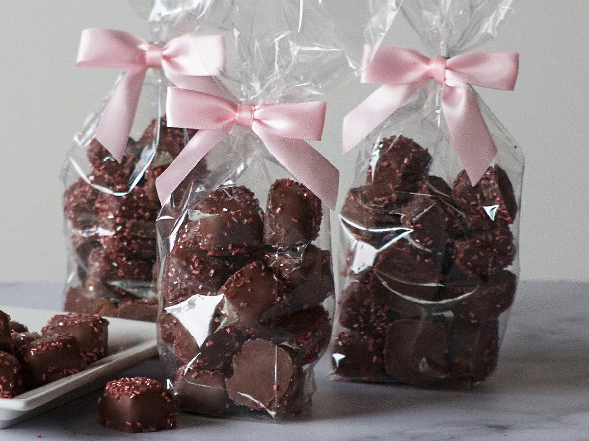 three bags of chocolates covered with pink sprinkles