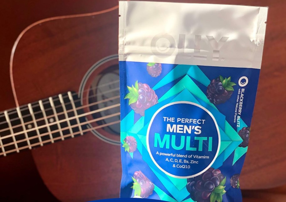 mens gummy vitamins in bag next to guitar