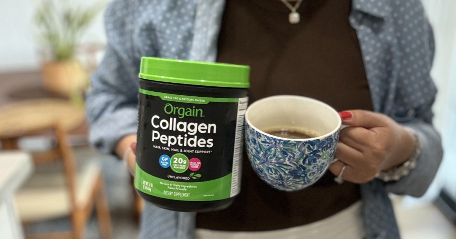 person holding an Orgain Hydrolyzed Collagen Peptides Powder container and a coffee cup