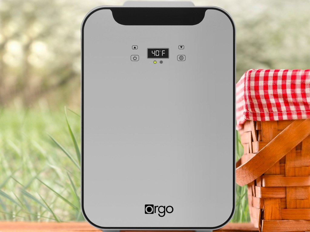gray orgo mini fridge on table next to picnic basket