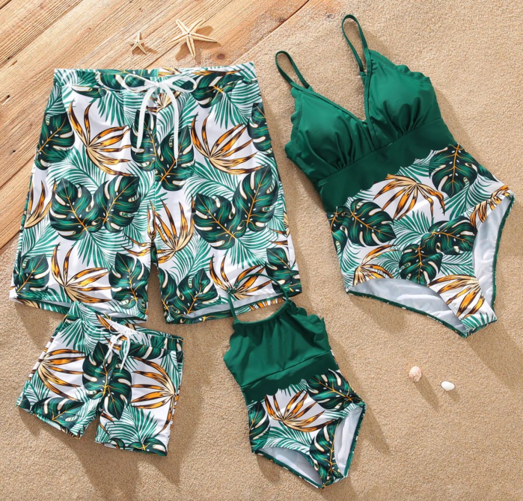 green tropical matching family swimsuits in pile