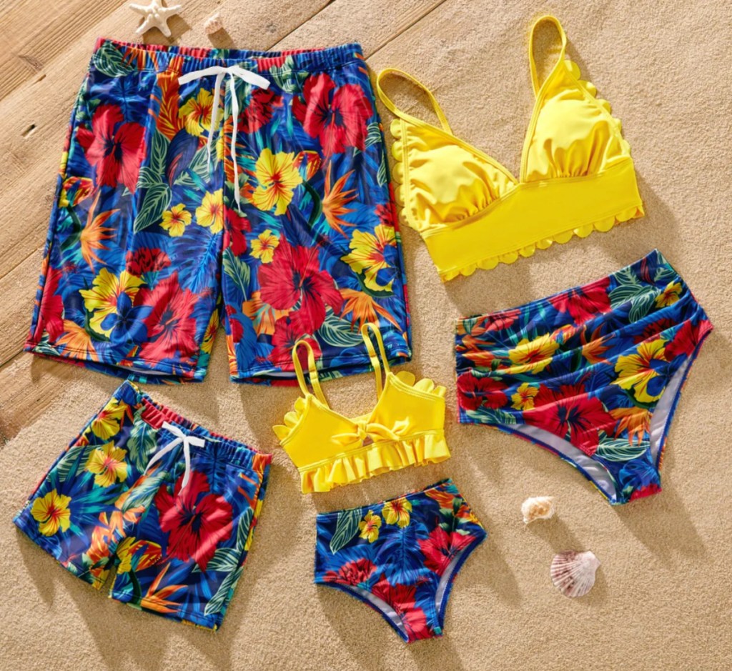 yellow and floral matching family swimsuits in a pile