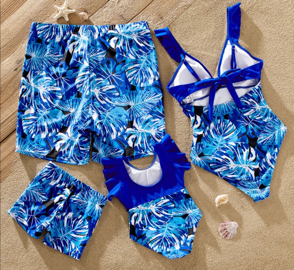 blue floral matching family swimsuits in a pile