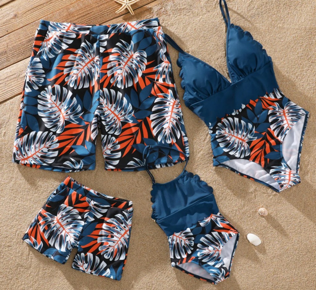 blue palm print family swimsuits in a pile