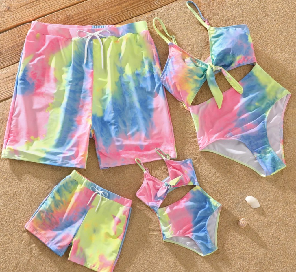 pink tie dye family swimsuits in a pile