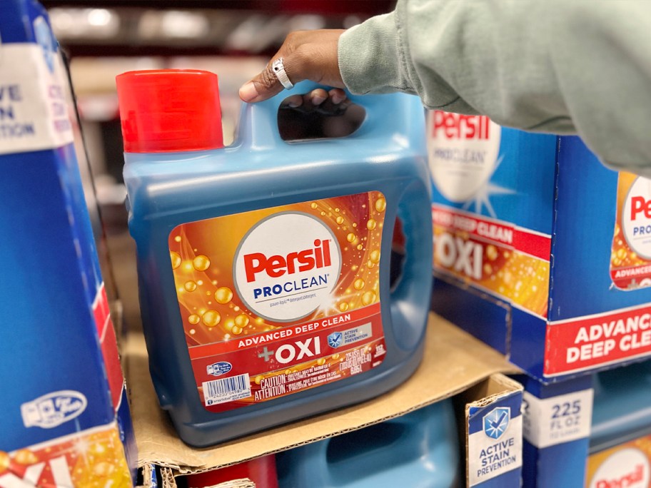 hand reaching for persil proclean laundry detergent