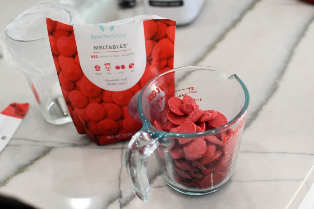 red candy melts in a glass container