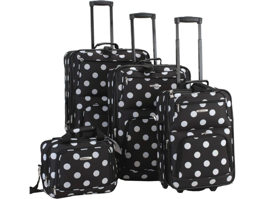 5 white and black polka dot luggage pieces