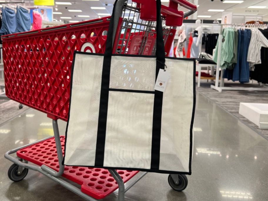 white tote hanging on target shopping cart