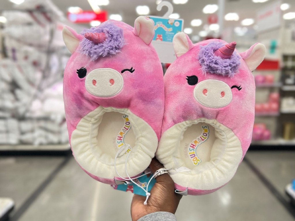 hand holding squishmallow unicorn slippers