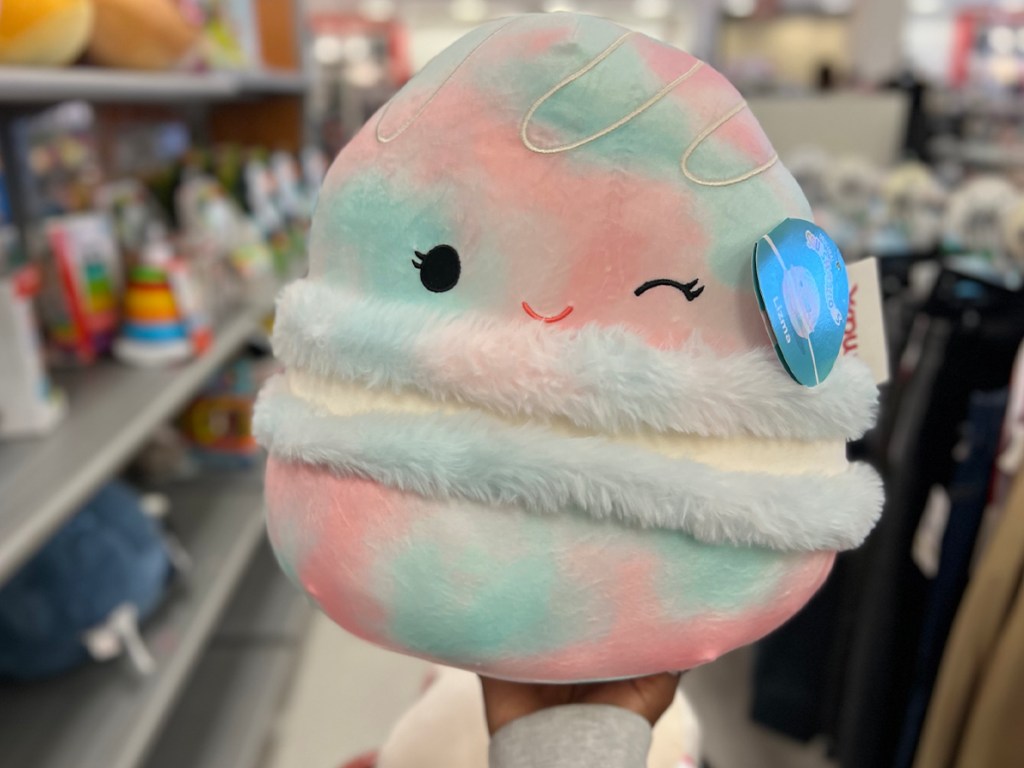 hand holding cotton candy pink and blue squishmallow