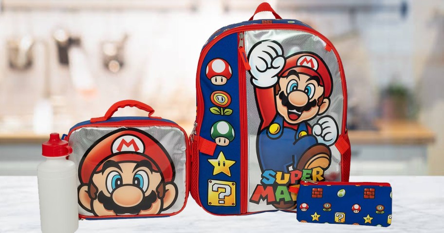 super mario backpack, lunchbox, water bottle and pencil pouch on table