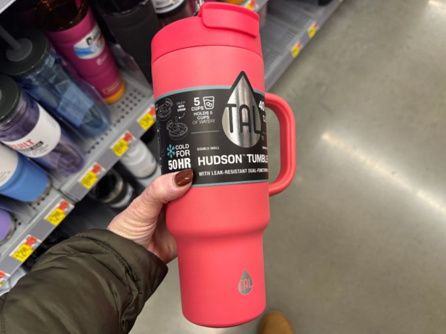 hand holding hot pink 40 oz Tal Tumbler in store aisle