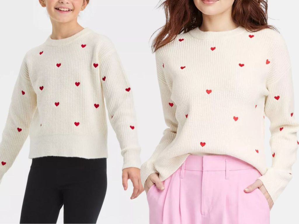 little girl and woman wearing a cream color sweater with red hearts