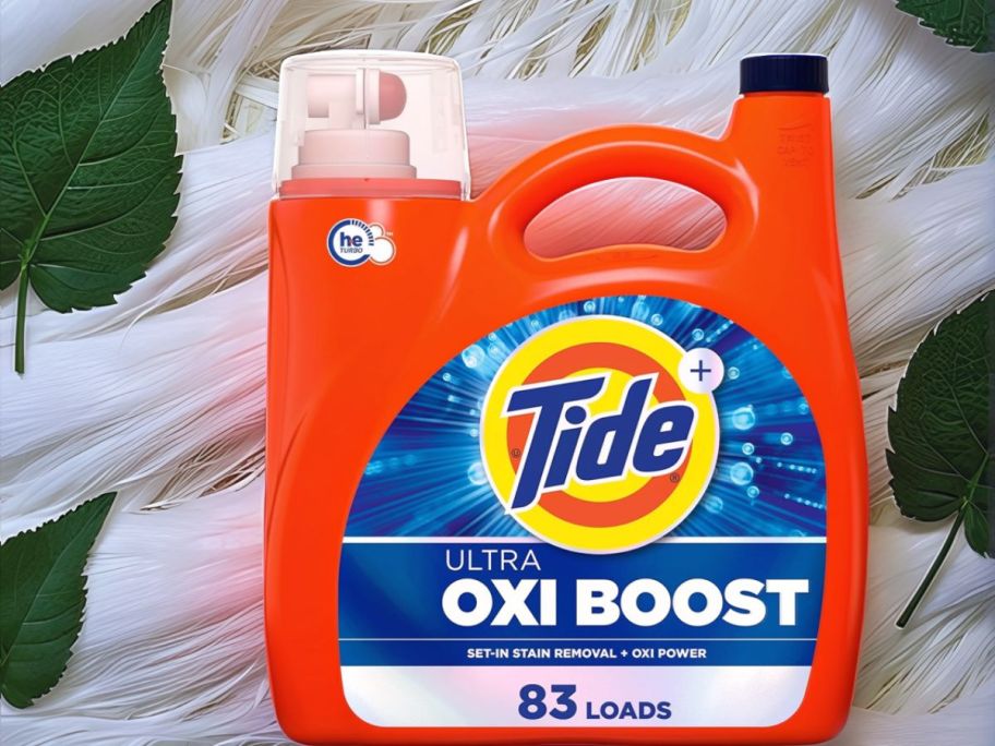Tide Ultra Oxi Boost with leaves and white textured cloth in background