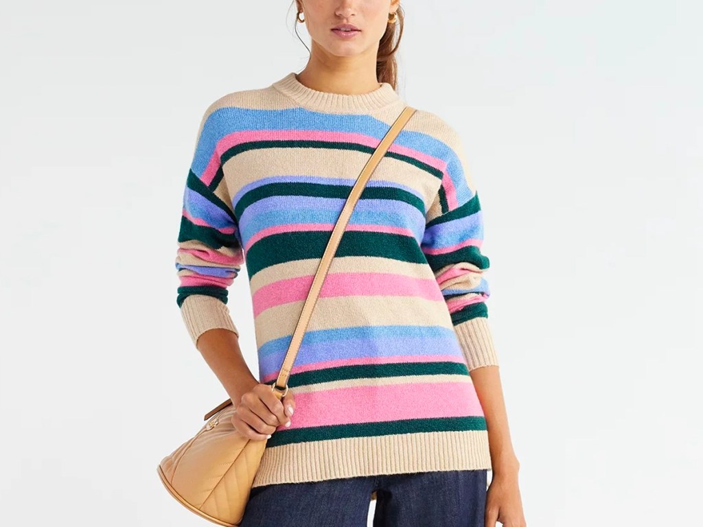 woman wearing striped sweater and purse