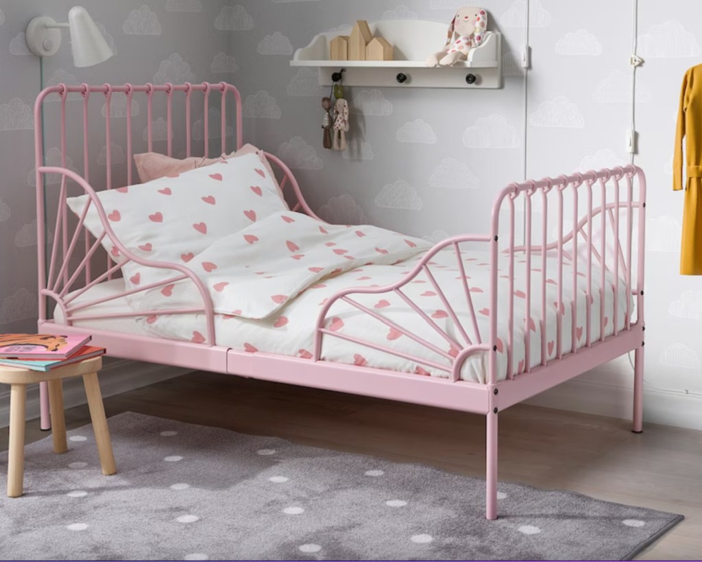 pink metal toddler bed with heart sheets
