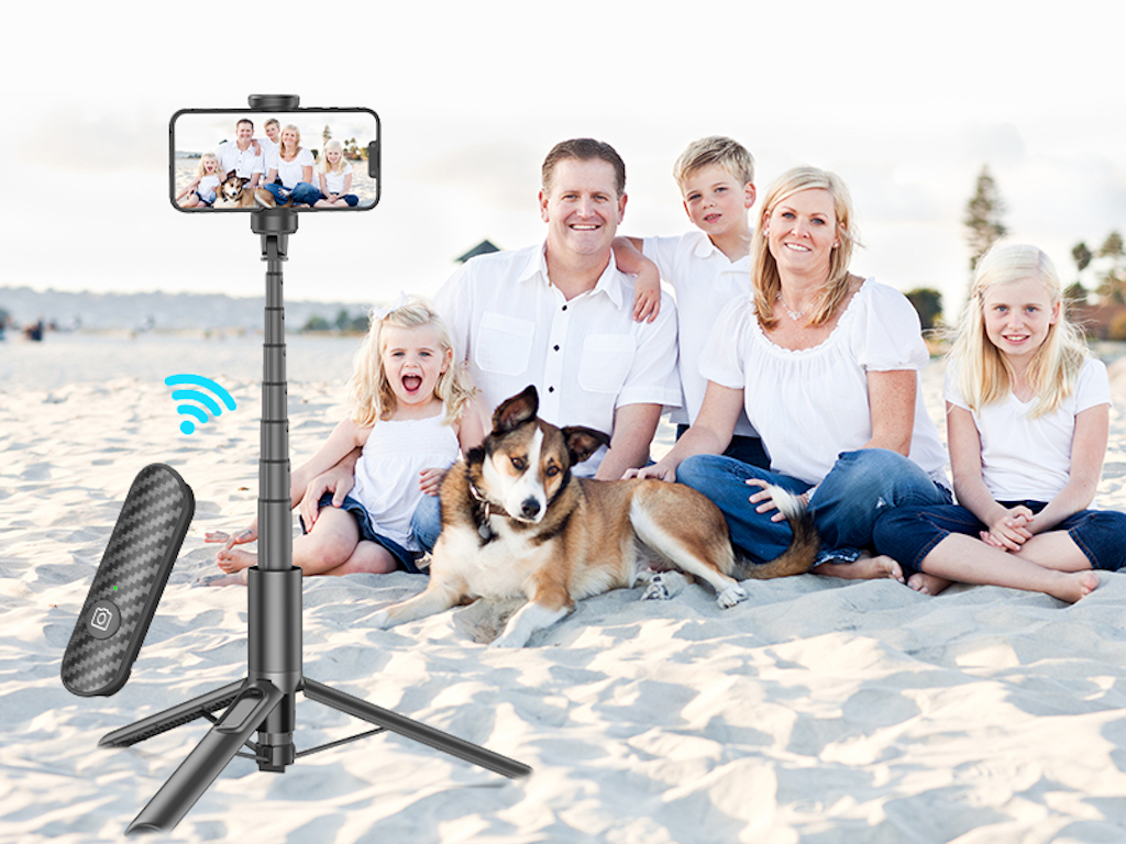 family using tripod stand for photo 