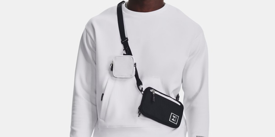 man in white sweatshirt wearing black crossbody bag with pouch