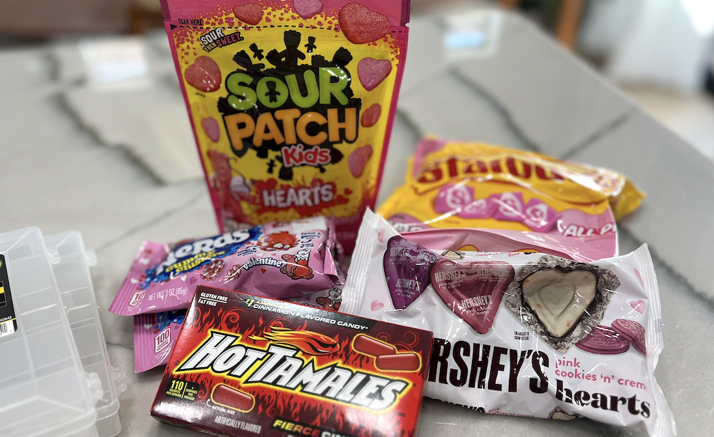Valentine's Day candy on counter - Sour Patch Kids, Hot Tamales, Starburst 