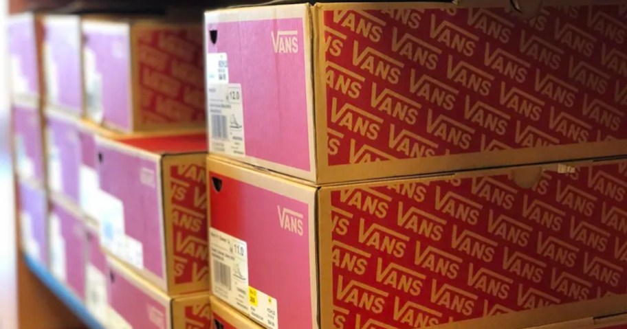 vans shoe boxes stacked on shelf in store