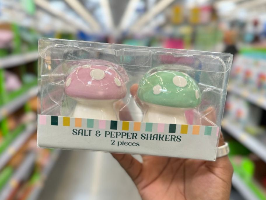 hand holding a package with Mushroom Salt & Pepper Shakers 
