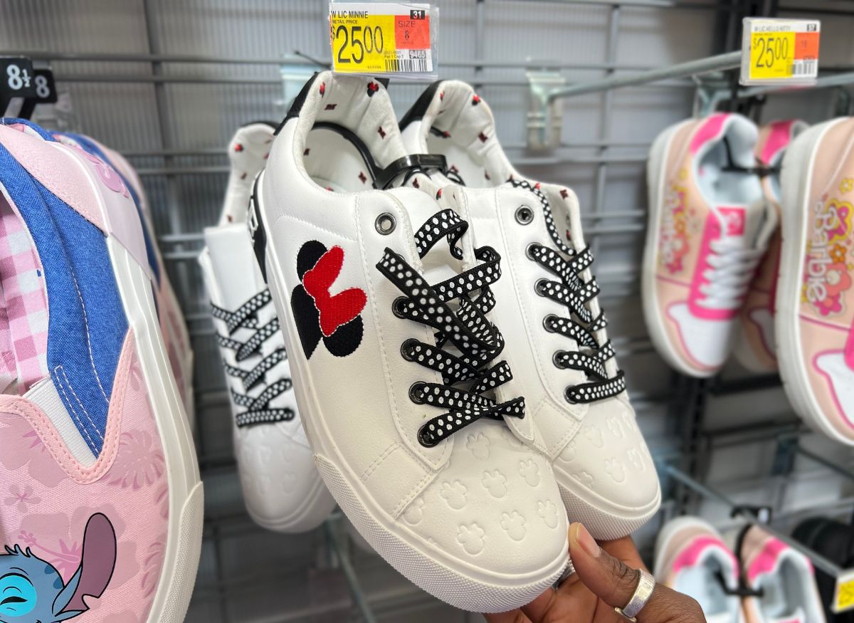 a pair of womens white low top lace up sneakers on a rack in a store