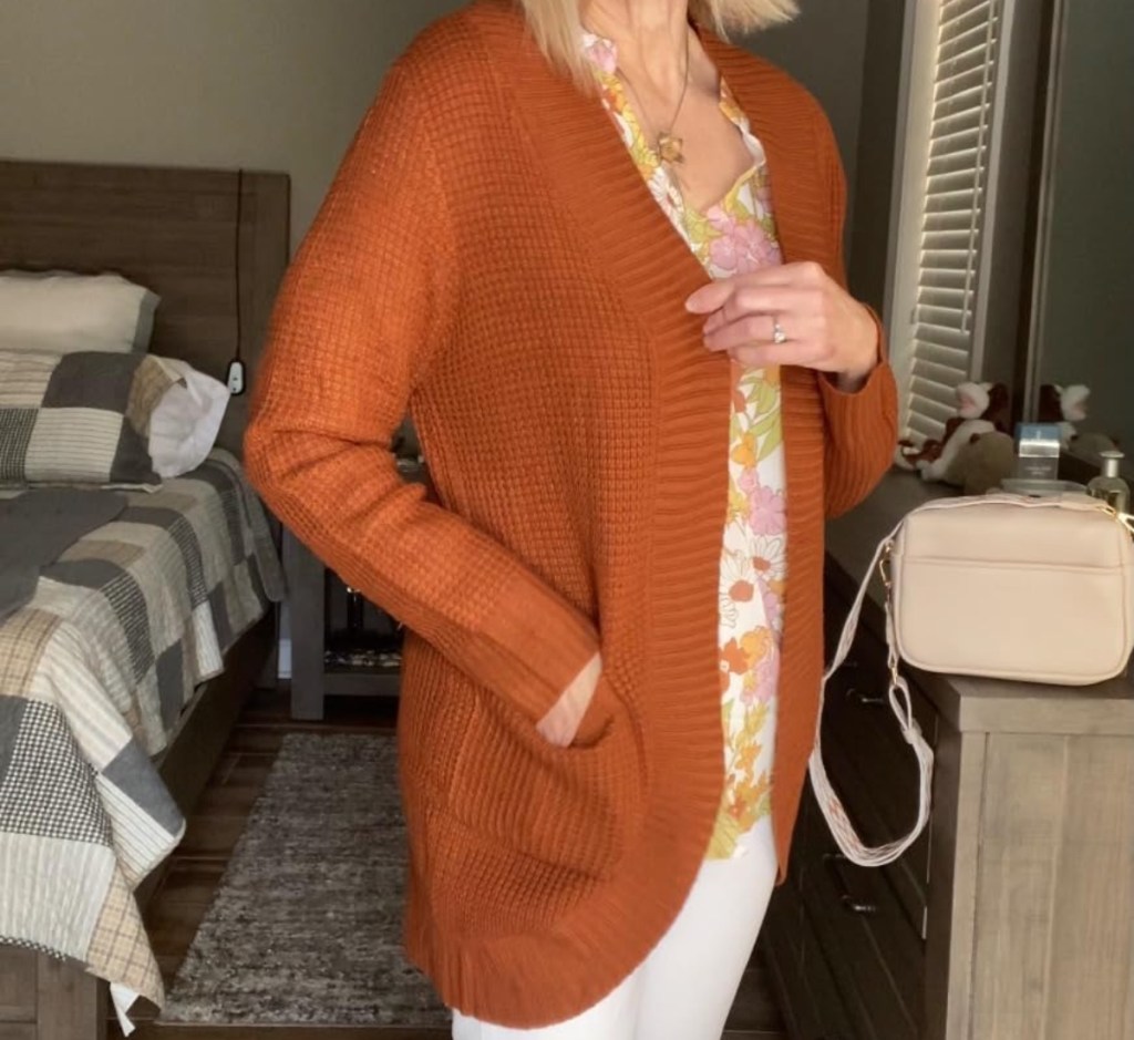 woman wearing rust colored cardigan