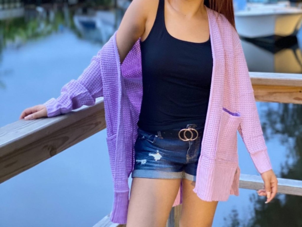 woman on boat dock wearing purple sweater