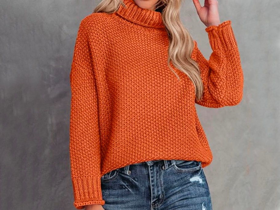 woman wearing orange turtleneck sweater with jeans