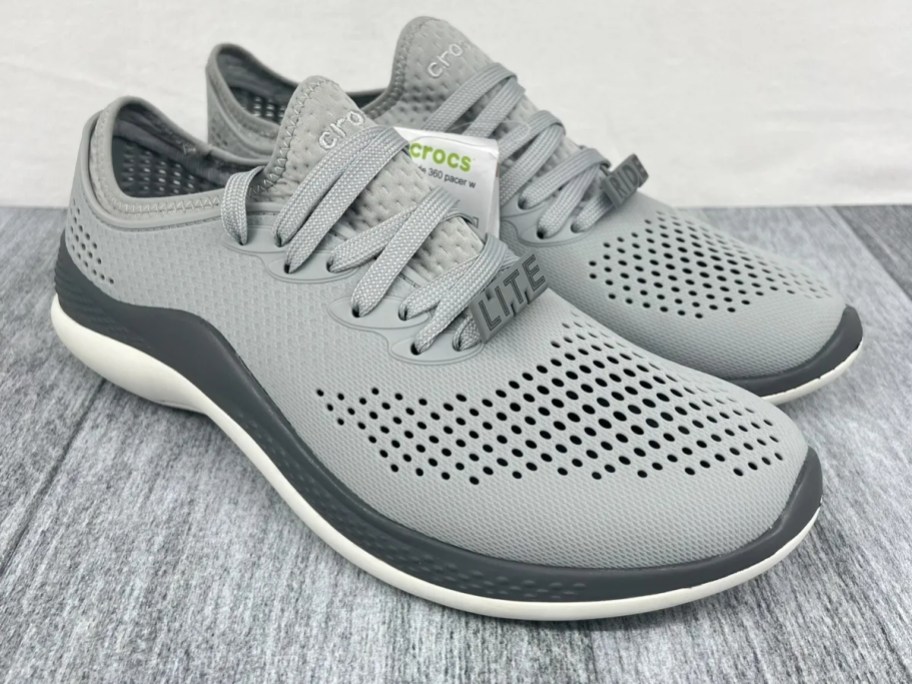 pair of light and dark gray men's Crocs tennis shoes
