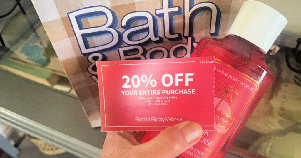 person holding 20% off coupon inside bath & body works