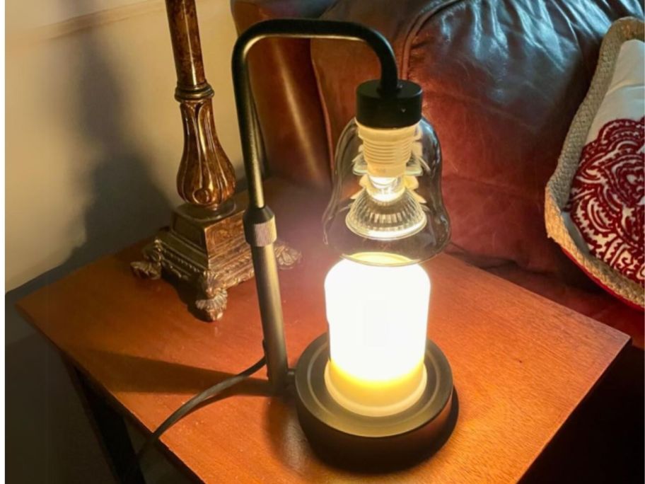black camdle warmer lamp with smokey grey semi clear shade warming a candle