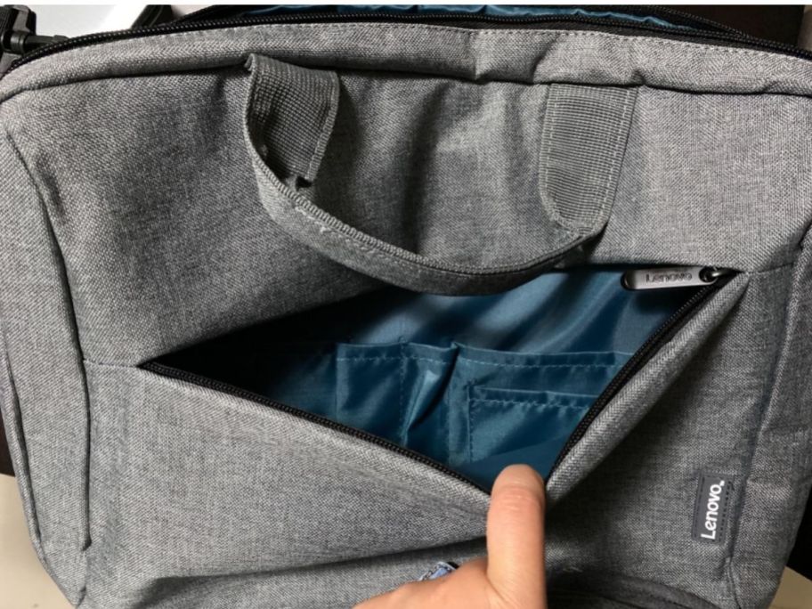 hand showing the outer pocket of a Lenovo Laptop Shoulder Bag 