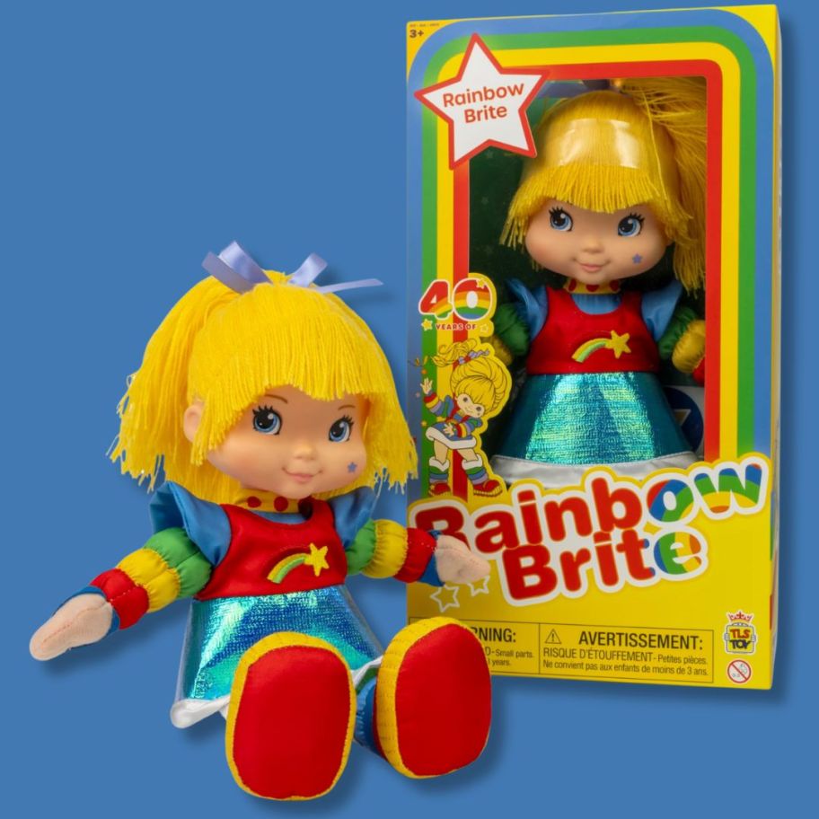 large plush Rainbow Brite doll sitting beside a doll in the packaging