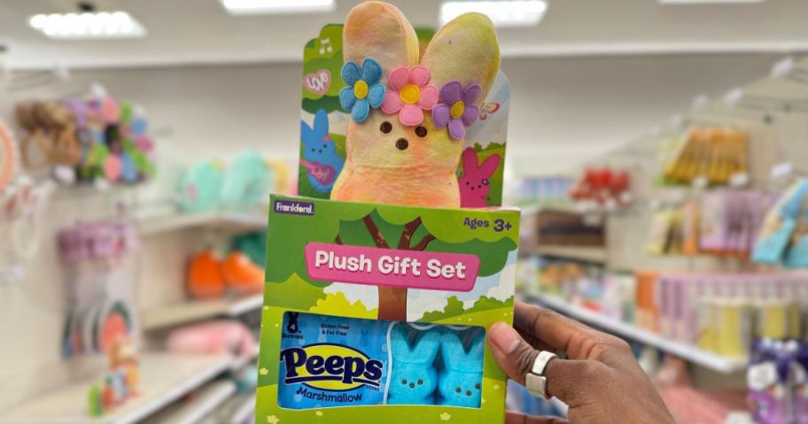 hand holding a Peeps Plush and Candy gift set in store