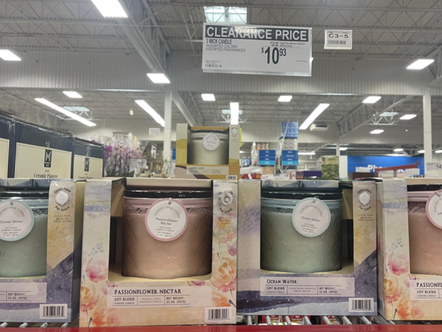 3 wick candles displayed at sams club store with price sign above it