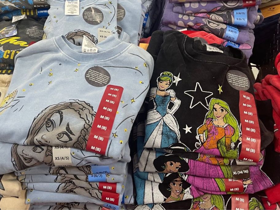 girl's Disney Princess Mineral Washed Crewneck Pullover shirts on display table